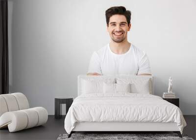 Happy young excited emotional man posing isolated over white wall background. Wall mural