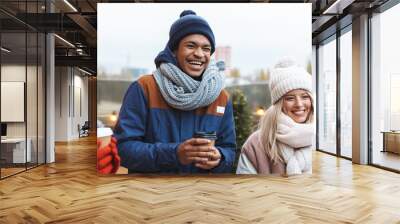 happy young friends talking with each other drinking coffee outdoors winter concept. Wall mural