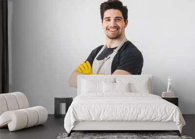 Happy young houseman househusband isolated over white wall background. Wall mural