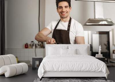 Happy young man chef cook in apron Wall mural