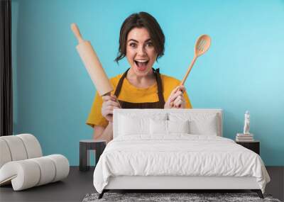 Happy young woman chef holding rolling pin Wall mural