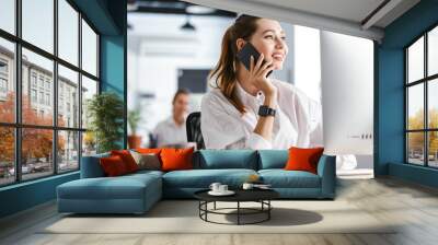 Happy young woman dressed in shirt Wall mural