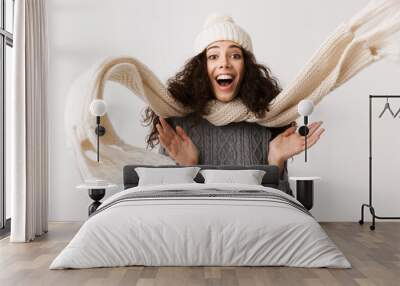 Happy young woman wearing winter clothes Wall mural