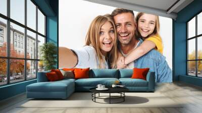 Image of adorable caucasian family woman and man with little girl smiling and taking selfie photo together Wall mural