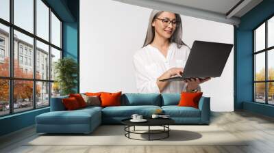 Image of adult mature woman wearing office clothes using laptop computer Wall mural