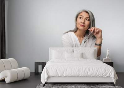 Image of adult mature woman with long gray hair wearing office clothes Wall mural