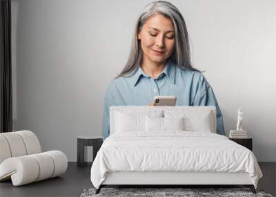 Image of adult mature woman with long white hair holding cellphone Wall mural