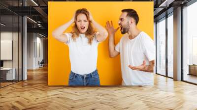 Image of arguing couple man and woman in basic t-shirts screaming at each other during fight Wall mural