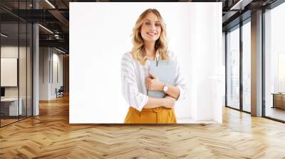 Image of attractive elegant businesswoman holding clipboard in office Wall mural