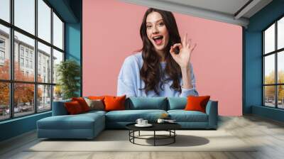 Image of attractive young woman smiling and gesturing okay sign Wall mural