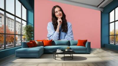 Image of attractive young woman smiling and looking upward at copyspace Wall mural