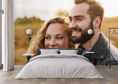 Image of beautiful couple dating and walking together in countryside Wall mural