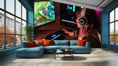 Image of caucasian focused girl playing video game on personal computer Wall mural