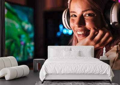 Image of caucasian happy girl in headphones playing video game Wall mural