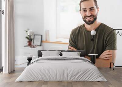 Image of caucasian happy man looking and smiling at camera Wall mural