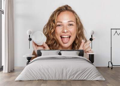 Image of cheerful half-naked woman making fun with facial cream Wall mural