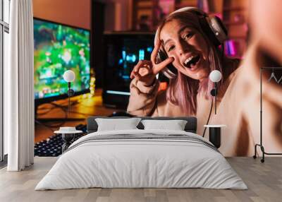 Image of excited girl taking selfie photo while playing video game Wall mural