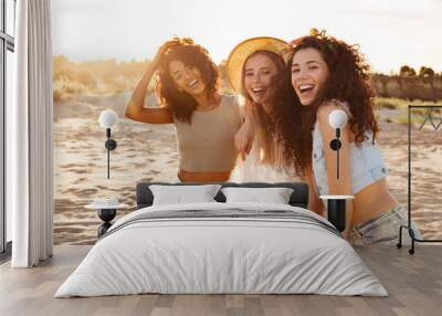 Image of gorgeous caucasian and african american women 20s in stylish clothing laughing and enjoying summertime, while spending weekend at seaside Wall mural