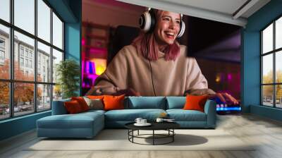 Image of joyful girl smiling and playing video game on computer Wall mural