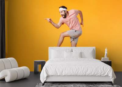 Image of muscular athletic young man having fun while doing workout Wall mural