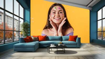 Image of young cheerful woman with stickers on face smiling at camera Wall mural