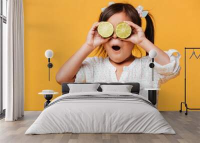 Little cute girl child covering eyes with lime. Wall mural