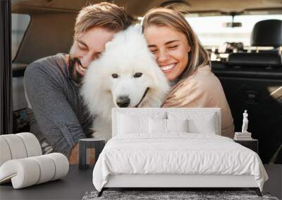 Lovely young happy couple sitting Wall mural