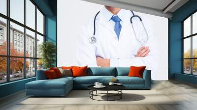 Male doctor standing with arms folded Wall mural