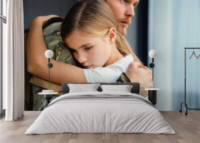 Masculine sad military man hugging her upset daughter indoors Wall mural