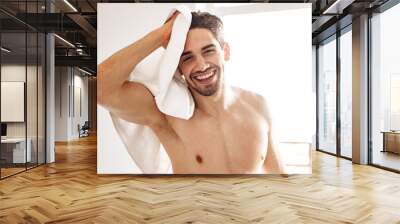 Naked man standing indoors at bathroom Wall mural