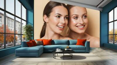 Optimistic beautiful blonde and brunette women. Wall mural