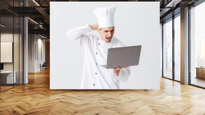 Pensive chef cook wearing uniform Wall mural