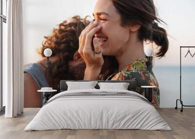 Photo closeup of funny young couple laughing and hugging Wall mural