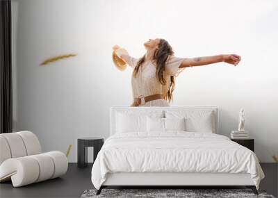 photo of beautiful happy woman smiling and dancing on wheat field Wall mural