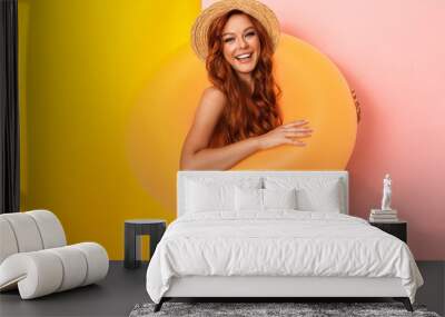 Photo of redhead pretty woman wearing straw hat and swimsuit standing in swim ring and smiling Wall mural