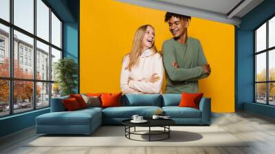 Photo of teenage people man and woman 16-18 with dental braces smiling, isolated over yellow background Wall mural