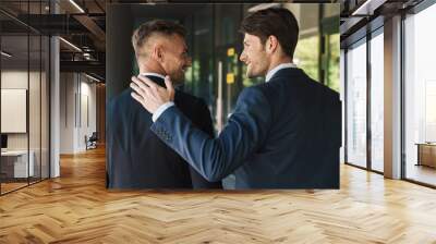 Portrait closeup from back of two confident businessmen partners standing outside job center during working meeting Wall mural