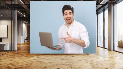 Portrait of a cheerful handsome young man Wall mural