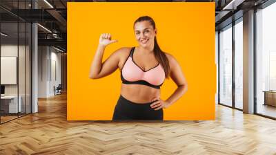 Portrait of a cheerful overweight fitness woman Wall mural