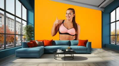 Portrait of a cheerful overweight fitness woman Wall mural