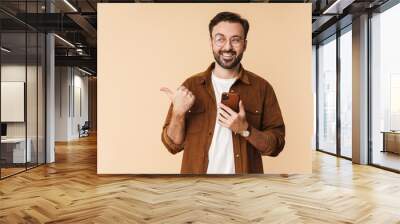 Portrait of a cheerful young arttractive bearded man Wall mural