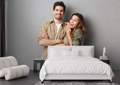 Portrait of a cheerful young couple standing together Wall mural