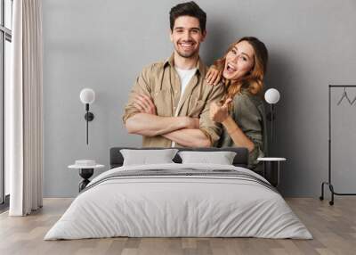 Portrait of a cheerful young couple standing together Wall mural