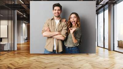 Portrait of a cheerful young couple standing together Wall mural