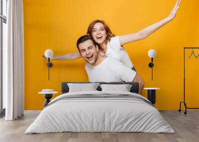 Portrait of a cheerful young couple standing Wall mural