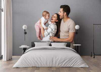 Portrait of a cheerful young family Wall mural