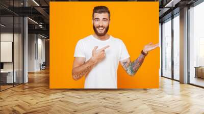 Portrait of a cheerful young man wearing casual clothes Wall mural