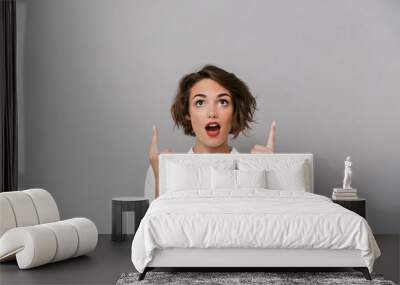 Portrait of a cheerful young woman dressed in white shirt Wall mural