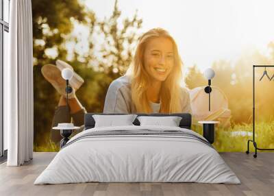 Portrait of a cheery young girl with backpack Wall mural