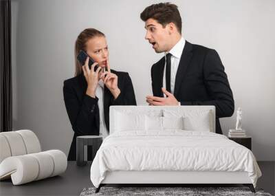 Portrait of a confident young business couple wearing suits Wall mural